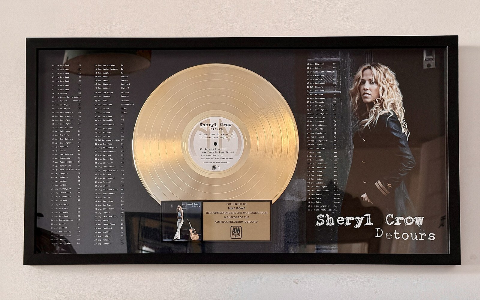 Framed gold record award for Sheryl Crow's "Detours" album with tour dates and her portrait