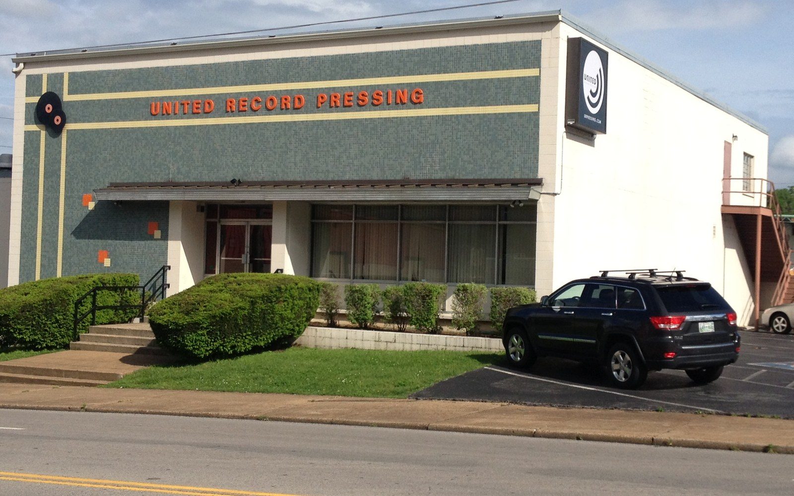 United Record Pressing building exterior with a parked SUV out front