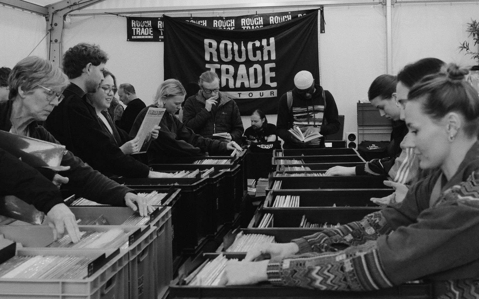 The counter and record-rack interior of the Rough Trade shop, a staff member visible behind the counter